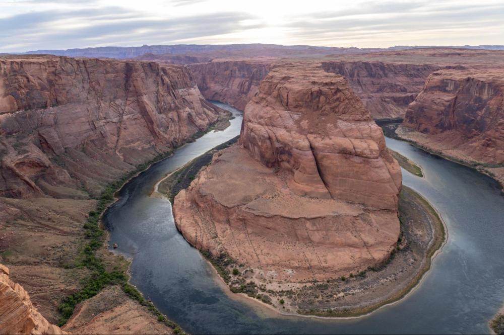 Scenic view of Horseshoe Bend with a river curving around a rock formation.